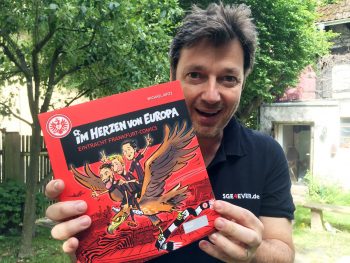 Michael Apitz präsentiert stolz den neuen Sammelband der Eintracht-Comics